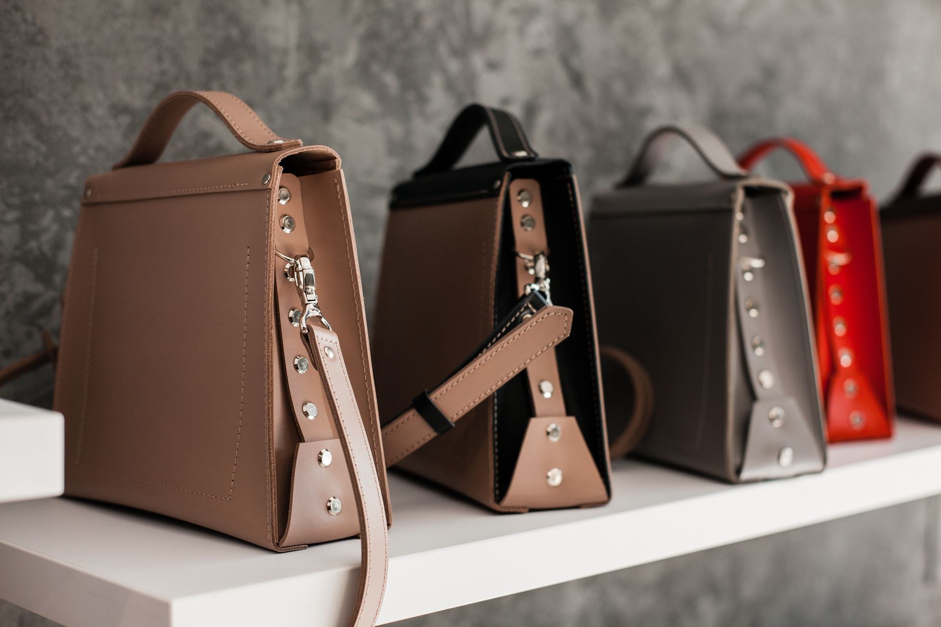 Women leather bag with hand-stitched edges and custom gold hardware